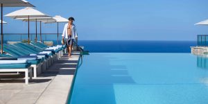 Jumeirah-Port-Soller-Infinity-Pool-Bar-Swimming-Swim-Horizon-Model-Lifestyle-front-Blue-Water-Sky-Architecture